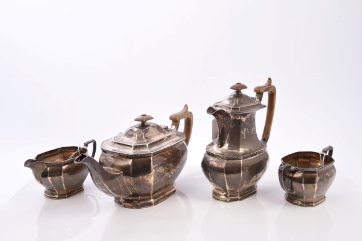 Contemporary silver four piece tea set comprising teapot of faceted form,