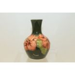 Moorcroft pottery bottle vase decorated in the Hibiscus pattern, on cream ground,