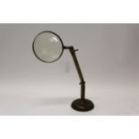 Desk magnifying glass on a weighted brass stand