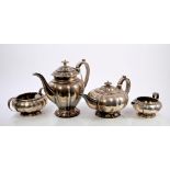 George IV silver four piece tea set, comprising teapot of compressed melon form, with fluted panels,