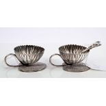 Pair fine quality silver salts in the form of lotus flowers, with loop handles, on lotus leaf bases,