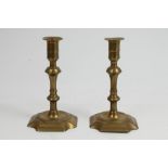 Pair of 18th century brass candlesticks, each with knopped column raised on canted square base,