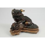 Japanese bronze and gilt splash Dog of Fo, modelled with paw upon an embroidered ball, 23cm wide,