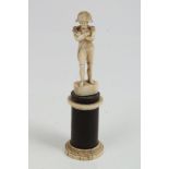 19th century Continental carved ivory figure of Napoleon raised on rosewood and bone column,