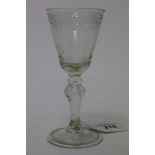 18th century Continental wine glass with floral engraved bowl on faceted and knopped stem with air