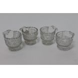 Four George IV Irish glass piggins with serrated tops,