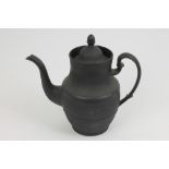 Early 19th century black basalt coffee pot and cover of baluster form with tapering neck, the