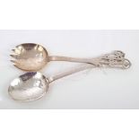 Pair 1920s silver salad servers in the Arts & Crafts-style, with spot-hammered bowls, flat stems and