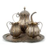 Late 19th century Indian white metal and parcel gilt three piece tea set, comprising teapot of