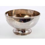 Contemporary Guild of Handicrafts silver bowl of circular form, with spot-hammered finish, on a