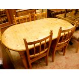 A 5' pine extending dining table with stowed leaf, set on turned legs - sold with a set of four