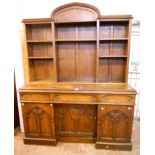 A 5' 6" late Victorian oak Gothic style double pedestal sideboard, with partitioned plate rack