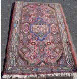 A Middle Eastern rug with polycrome geometrical and floral design - 3' 9¾" x 2' 7½" (1.16m x 0.80m)