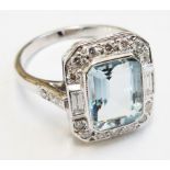 An 18ct. white gold ring, set with 2ct. emerald-cut aquamarine, within a diamond border with