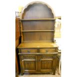 A 36" Old Charm polished oak Dutch style dresser, with dome top two shelf open plate rack, over a