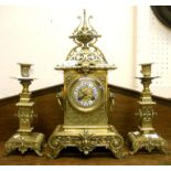 A 19th Century ornate brass clock garniture, with blue and white enamelled Roman numerals to dial
