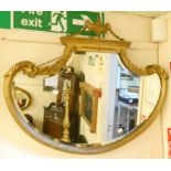 A 33" Regency style wall mirror with urn motif and acanthus decoration, reeded C-scroll frame and