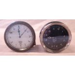 A Smiths M. A. dashboard clock with front bezel winder and set plunger at twenty minute mark -