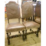 A set of six high back dining chairs with studded leather upholstery, set on ornate barley twist