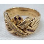 An 18ct. gold ornate keeper ring, set with rows of small diamonds and rubies