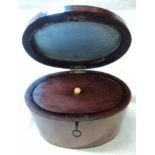 An early 19th Century oval box wood strung mahogany tea caddy, complete with key