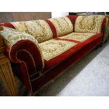 A 6' 4" late Victorian Chesterfield settee, with carpet bag style upholstery, set on turned legs
