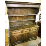 A 4' 7" 18th Century oak dresser, with two shelf open plate rack over a base with three frieze