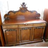 A 5' 1" Victorian mahogany sideboard with ornate Rococo style C-scroll set raised back, over three