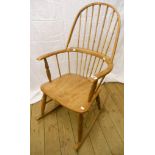 A comb back Windsor style rocking chair, with solid elm seat and turned supports