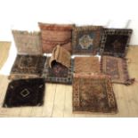 A quantity of Middle Eastern and other carpet bag panels - as cushions - various styles and age