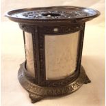An embossed metal pictorial lantern with translucent highly detailed parian panels - one with old