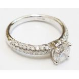 An 18ct. white gold diamond solitaire ring (1.01ct.), with diamond set shoulders - IGL certificate