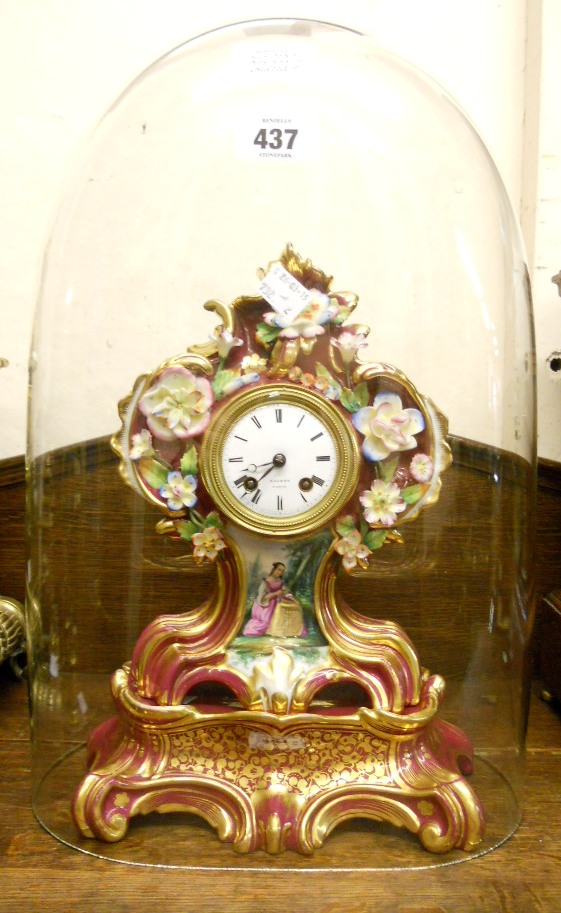 An early 19th Century porcelain cased mantel clock with floral encrusted decoration and painted