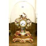 An early 19th Century porcelain cased mantel clock with floral encrusted decoration and painted