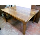 A 4' 10" oak dining table, set on turned legs with bun feet