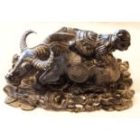 A late 19th Century Chinese carved wood man facing backward atop a water buffalo  - later