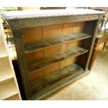 A 4' Victorian oak bookcase with carved decoration and four adjustable shelves, set on plinth base