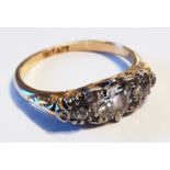 An 18ct. gold three stone diamond ring in elliptical setting