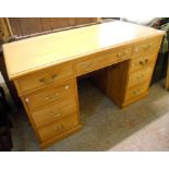 A 4' 7" modern blonde wood double pedestal desk, with three frieze drawers and six flanking pedestal