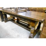 A 7' 6" solid oak plank top refectory dining table, with decorative carved frieze, set on turned