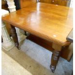 An Edwardian walnut extending dining table with canted corners, single leaf and winder, set on