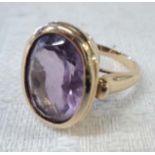 A 9ct. gold dress ring, set with large oval amethyst