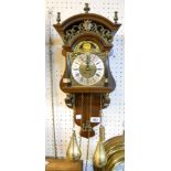 A reproduction mahogany cased ornate wall clock, with moon phase and twin brass plumb bob driven