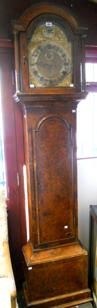 An 18th Century figured walnut and checkerboard strung longcase clock, the 12" brass and silvered