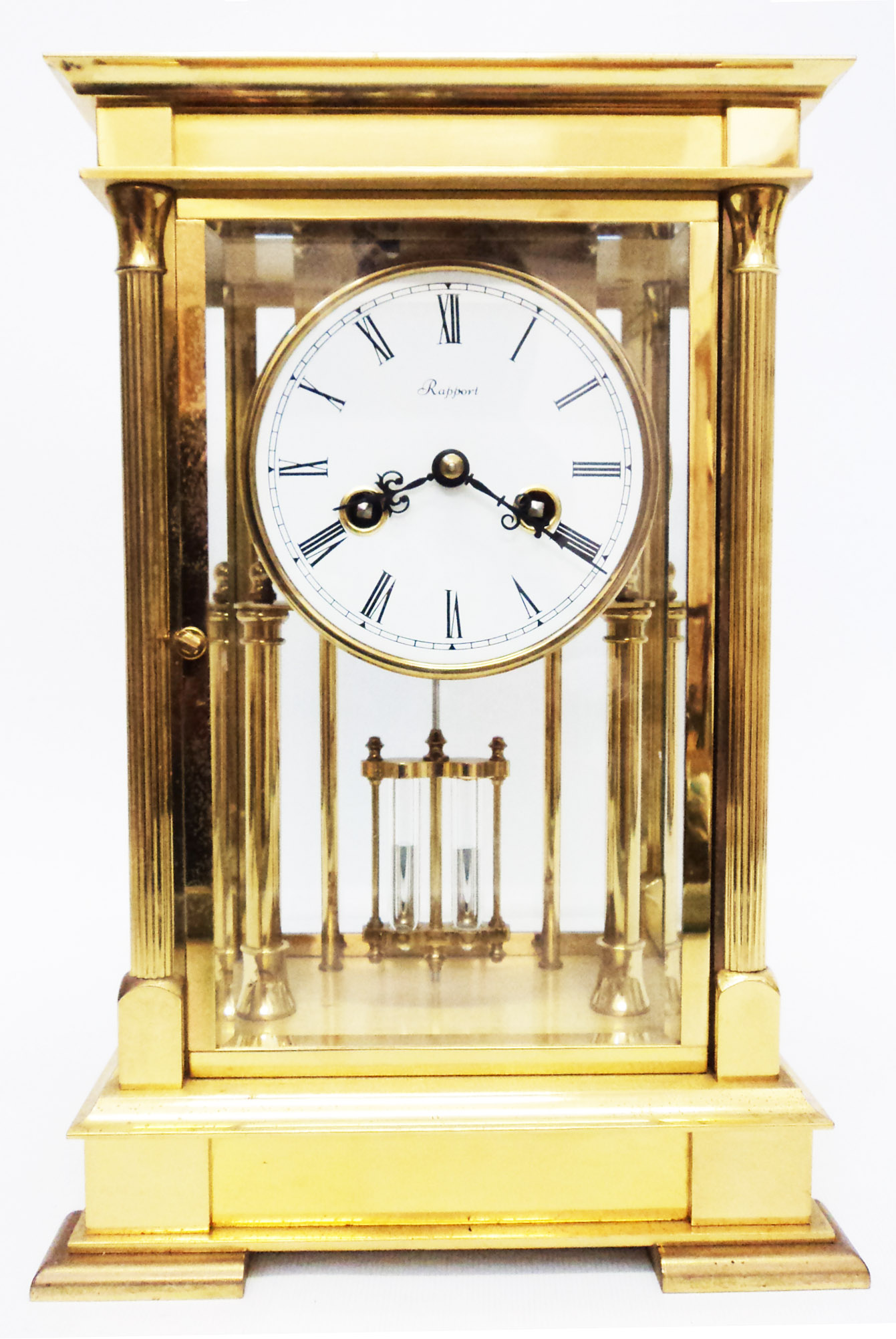 A 11 1/2" Rapport brass and four bevelled glass library clock, with Roman numerals to white dial,