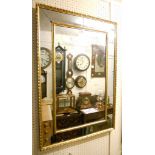 A Regency gilt framed mirror, with central rectangular plate and segmented surround within a