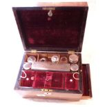 A late 19th Century rosewood dressing box, containing various silver and plate topped bottles and