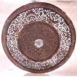 A Middle Eastern pierced copper plate with crescent moon and floral decoration