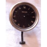 A Jaeger automobile dashboard clock with sprung winder, set stem to base and black dial