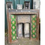 A late Victorian cast iron fire place in slate surround with decorative tiles